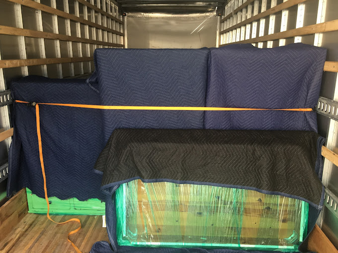 safely wrapped furniture loaded on moving truck and strapped down